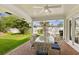 A covered patio with brick pavers, a ceiling fan, and a stylish dining set at 2401 Riverview Blvd, Bradenton, FL 34205