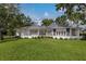Well-maintained backyard with a patio area, large windows, manicured lawn, perfect for outdoor living and entertaining at 2401 Riverview Blvd, Bradenton, FL 34205