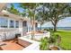 Outdoor patio area showcasing water views, a white retaining wall, and lush landscaping, creating a serene outdoor living space at 2401 Riverview Blvd, Bradenton, FL 34205