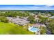 Wide aerial view of residential neighborhood featuring mature trees, community pool, and single story homes at 2915 29Th W Ave, Bradenton, FL 34205