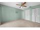Spacious bedroom with plush carpeting, a ceiling fan, and a closet at 2915 29Th W Ave, Bradenton, FL 34205