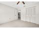 Bedroom with carpet flooring, a ceiling fan, and a closet with multiple doors at 2915 29Th W Ave, Bradenton, FL 34205