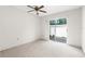Bedroom features carpeting, a ceiling fan, and a sliding glass door to the outside at 2915 29Th W Ave, Bradenton, FL 34205