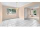 Dining room with tile flooring, a chandelier, and natural light from multiple windows at 2915 29Th W Ave, Bradenton, FL 34205