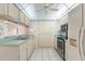 Traditional kitchen with white cabinets, green countertops, white appliances and tile flooring at 2915 29Th W Ave, Bradenton, FL 34205