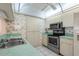Efficient kitchen with white cabinetry, stainless steel appliances and neutral tile flooring at 2915 29Th W Ave, Bradenton, FL 34205