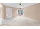 Open living area with neutral paint, carpet flooring, ceiling fan, and ample natural light at 2915 29Th W Ave, Bradenton, FL 34205
