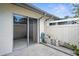 Patio sliding glass door with gray concrete pad, gutter, and partial view of privacy fence at 2915 29Th W Ave, Bradenton, FL 34205
