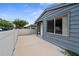Wide angle showing the home's patio with privacy fence and concrete, side window, and siding at 2915 29Th W Ave, Bradenton, FL 34205