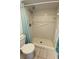 Bathroom featuring a walk-in shower with tile flooring, safety bars and a bright blue shower curtain at 3032 Heron Lake Ct # 7B, Venice, FL 34293