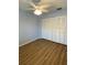 Bedroom with wood floors, a ceiling fan, and large closet doors provides ample storage space at 3032 Heron Lake Ct # 7B, Venice, FL 34293