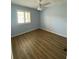 Bedroom features a large window and wood floors providing ample natural light and a modern feel at 3032 Heron Lake Ct # 7B, Venice, FL 34293