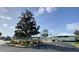 Exterior view of the community's East Village Center, with landscaped grounds and ample parking at 3032 Heron Lake Ct # 7B, Venice, FL 34293