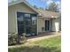 Exterior view featuring a paved patio and a small sun room, perfect for outdoor relaxation and enjoyment at 3032 Heron Lake Ct # 7B, Venice, FL 34293