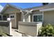 Inviting front entrance with beige siding and brick accents, creating a warm and welcoming atmosphere at 3032 Heron Lake Ct # 7B, Venice, FL 34293
