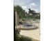 Community hot tub with lounge chairs and shade umbrellas beside the tennis court at 3032 Heron Lake Ct # 7B, Venice, FL 34293