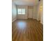 Bright living room with modern flooring and a large window, offering a comfortable and inviting space at 3032 Heron Lake Ct # 7B, Venice, FL 34293