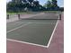 Exterior of community tennis courts featuring new nets and updated surface and fencing at 3032 Heron Lake Ct # 7B, Venice, FL 34293