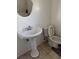 Bathroom with pedestal sink, toilet, mirror, and tile floors at 3404 56Th Dr E, Bradenton, FL 34203