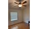 Bedroom with wood floors, ceiling fan, and a window filled with natural light at 3404 56Th Dr E, Bradenton, FL 34203