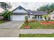 Charming home with a well-maintained lawn, mature trees, and an attached two-car garage at 3404 56Th Dr E, Bradenton, FL 34203