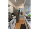 Well-equipped kitchen with modern appliances, white cabinets, and hardwood flooring at 3404 56Th Dr E, Bradenton, FL 34203