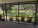 Relaxing screened-in porch with serene views of the backyard pond and lush landscaping at 3404 56Th Dr E, Bradenton, FL 34203