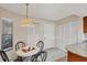 Breakfast nook with a view from window, with table, chairs and pendant lighting at 3617 Yellow Pine Ct # 144, Sarasota, FL 34238