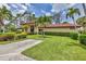 Attractive building with a red tile roof, framed by palm trees and well-manicured lawns at 3617 Yellow Pine Ct # 144, Sarasota, FL 34238