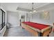 Bright game room with a full-size billiard table, tile floors, and ample natural light at 3617 Yellow Pine Ct # 144, Sarasota, FL 34238
