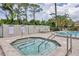 Enjoy a relaxing hot tub with the convenience of an adjacent pool and plenty of lounge chairs at 3617 Yellow Pine Ct # 144, Sarasota, FL 34238