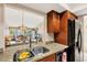 Kitchen sink overlooking the living area, featuring granite countertops and wood cabinets at 3617 Yellow Pine Ct # 144, Sarasota, FL 34238