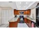 Well-equipped kitchen with granite countertops, dark cabinets, and modern appliances at 3617 Yellow Pine Ct # 144, Sarasota, FL 34238