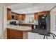 Modern kitchen with granite countertops, stainless steel appliances, and dark wood cabinets at 3617 Yellow Pine Ct # 144, Sarasota, FL 34238
