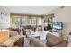 Bright living room with tile flooring, large windows, and comfortable furnishings at 3617 Yellow Pine Ct # 144, Sarasota, FL 34238