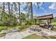 Community picnic area with BBQ grills, picnic table, and nearby pond at 3617 Yellow Pine Ct # 144, Sarasota, FL 34238