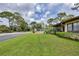 Lush green lawn with a walking path, and a tennis court view in the background at 3617 Yellow Pine Ct # 144, Sarasota, FL 34238