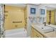 Bright bathroom featuring yellow tiles, vanity with sink, and bathtub at 3721 Somerville Dr # 1513, Sarasota, FL 34232
