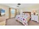 Bright bedroom featuring a colorful quilt, ceiling fan, and a lovely window view at 3721 Somerville Dr # 1513, Sarasota, FL 34232
