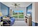 Cozy bedroom with a ceiling fan and sliding door leading to a lush green lawn view at 3721 Somerville Dr # 1513, Sarasota, FL 34232