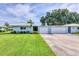 Charming single-story home with a well-manicured lawn, lush landscaping, and a two-car garage at 3721 Somerville Dr # 1513, Sarasota, FL 34232