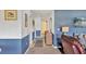 Hallway with blue and white accents, art, and a view into the living area at 3721 Somerville Dr # 1513, Sarasota, FL 34232
