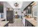Functional kitchen with stainless steel appliances, dark cabinets, and tiled floor at 3721 Somerville Dr # 1513, Sarasota, FL 34232