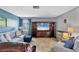 Inviting living room with plush seating, entertainment center, and natural light from the window at 3721 Somerville Dr # 1513, Sarasota, FL 34232