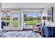 Bright living room with large windows, comfortable chair, and view of the lawn at 3721 Somerville Dr # 1513, Sarasota, FL 34232