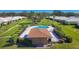 Aerial view of a pool with covered eating area and lounge chairs amidst lush landscaping at 3721 Somerville Dr # 1513, Sarasota, FL 34232