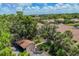 Aerial view showcasing the community, landscaping, and surrounding lush greenery of the property at 3810 75Th W St # 128, Bradenton, FL 34209
