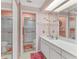 Well-lit bathroom featuring a sleek white vanity, a large mirror, and an accessible walk-in shower at 3810 75Th W St # 128, Bradenton, FL 34209