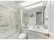 Bathroom features a skylight and shower-tub combo with glass doors at 3810 75Th W St # 128, Bradenton, FL 34209