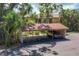 Open carport providing covered parking space with a view of the building and surrounding trees at 3810 75Th W St # 128, Bradenton, FL 34209